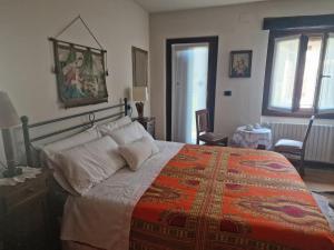 a bedroom with a large bed with a red blanket at Ginetta in Madonna del Sasso