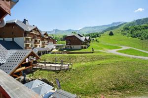 an aerial view of a village with mountains in the background at A3 405 Appart au pied des pistes in Saint-François-Longchamp