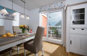 a kitchen with a desk with a chair and a window at Happy Holidays in Olpenitz