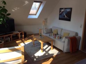 a living room with a couch and a table at Haus am Herrenwall in Esens
