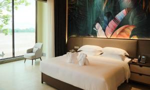 Postel nebo postele na pokoji v ubytování MonMonBoutique Hotel