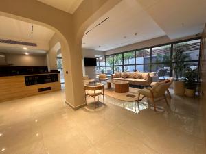 a living room with a couch and a table and chairs at Lacasa Residence in Cairo