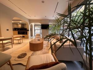a living room with a table and a plant at Lacasa Residence in Cairo
