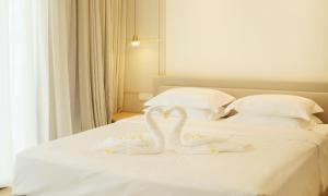 Postel nebo postele na pokoji v ubytování MonMonBoutique Hotel