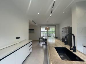 a kitchen with a sink and a table in it at Stanford Garden in Shanghai