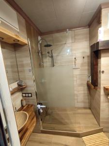 a shower with a glass door in a bathroom at Mroczne marzenie in Przemyśl