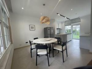 a kitchen and dining room with a table and chairs at Stanford Garden in Shanghai +8 photos
