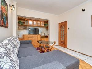 a living room with a couch and a table at Апартамент Бриз in Burgas