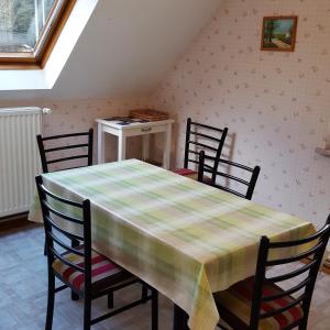 een eetkamer met een tafel en vier stoelen bij Locations Dupertuis Alsace in Le Hohwald