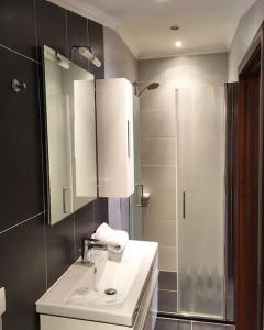 a bathroom with a sink and a shower at Appartamento vista mare in Centro Storico in Scalea +29 photos