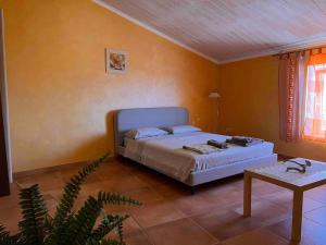 a bedroom with a bed and a table in it at Appartamento vista mare in Centro Storico in Scalea