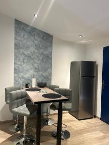 a dining room with a table and a refrigerator at Maison de ville neuve et moderne in Saint-Dizier +16 photos