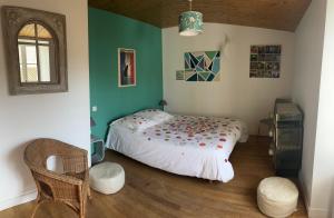 a bedroom with a bed in the corner of a room at Maison typique de pêcheur in Noirmoutier-en-l'lle