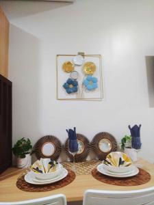 a table with plates and dishes on top of it at SMDC Style Residences Condo Unit in Iloilo City +15 photos