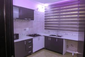 a kitchen with white counters and a sink and a stove at Stunning 3-Bed House in Lagos in Lagos
