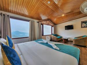 a bedroom with a bed with a swan on it at Hotel Surya Shimla in Shimla +99 photos
