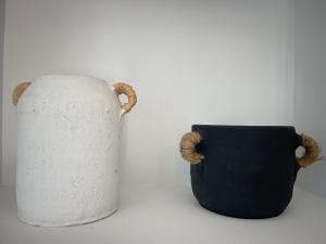 a black and white vase sitting next to a cup at Agroktima Drosou Apartment in Ancient Epidauros