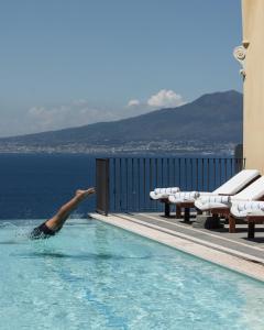a person is diving into a swimming pool at Grand Hotel Angiolieri in Vico Equense