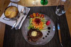 a plate of food with meat and vegetables on a table at Auberge Obersolberg in Eschbach-au-Val