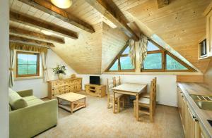 a kitchen and living room with a table and chairs at Apartmány a Štúdiá Lúčky, SKI-IN SKI-OUT ,Chopok Jasná, Demänovská dolina in Demanovska Dolina