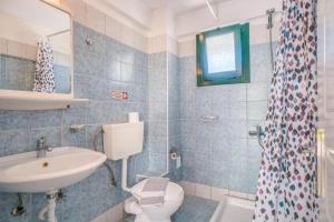 a bathroom with a sink and a toilet and a shower at Anna Studios in Arillas +67 photos