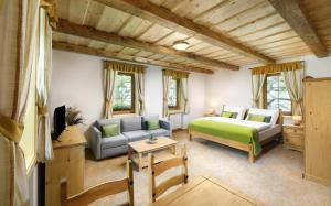 a bedroom with a bed and a couch at Apartmány a Štúdiá Lúčky, SKI-IN SKI-OUT ,Chopok Jasná, Demänovská dolina in Demanovska Dolina