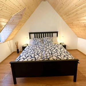 a bedroom with a large bed in an attic at Kuca Breg in Slapnica