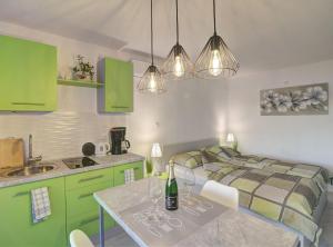 - une cuisine avec des armoires vertes et un lit dans une chambre dans l'établissement Apartments Luka & Leona, à Senj 30 autres photos