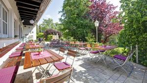 a group of tables and chairs on a patio at Landhaus am Rehwald in Donzdorf