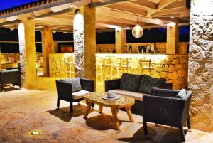 a living room with a couch and chairs and a table at Petani Bay Hotel - Adults Only in Vóvikes