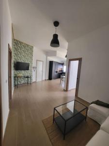 a living room with a couch and a glass table at La casita in Los Menores