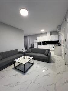a living room with a couch and a coffee table at Apartments Melina in Korinós