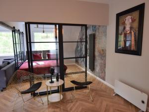 a living room with two chairs and a swing at Apartment near Lake Radunskie in Stezyca in Stężyca