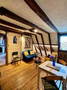a living room with a couch and a table at Le Petit Tinténiac - T2 cosy au cœur de la Doutre in Angers