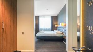 Postel nebo postele na pokoji v ubytování X Hotel