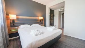 Postel nebo postele na pokoji v ubytování X Hotel