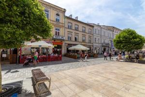 a city street with people walking around and buildings at Apartament Na Deptaku 23 in Lublin