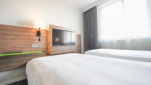 Postel nebo postele na pokoji v ubytování X Hotel