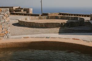 a pool of water in a yard with three steps at Venue Villas - Folegandros in Áno Meriá