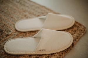 a pair of white shoes sitting on a rug at Venue Villas - Folegandros in Áno Meriá
