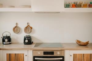 a kitchen with a counter top with a stove at Venue Villas - Folegandros in Áno Meriá