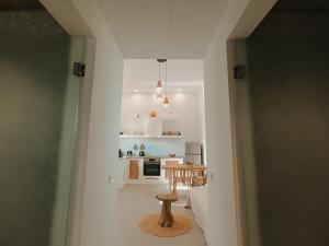 a small kitchen with a table in a room at Venue Villas - Folegandros in Áno Meriá