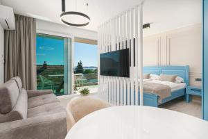 a living room with a bed and a tv at Luxury Apartments Maja Vodice in Srima