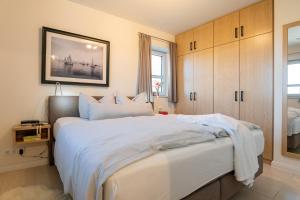 Ένα ή περισσότερα κρεβάτια σε δωμάτιο στο Haus Zur Mole, Wohnung 18 Spinnaker