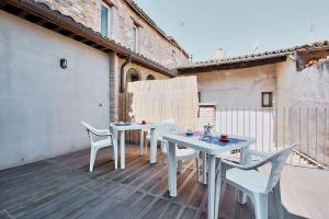 a white table and chairs on a patio at Casa Massarelli in San Severino Marche