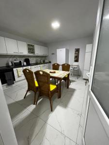 a kitchen with a table and chairs in a room at Vacation villa Sucevița in Suceviţa