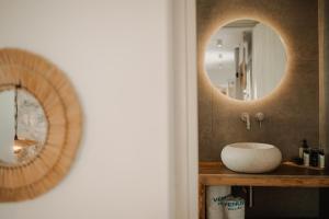a bathroom with a sink and a mirror at Venue Villas - Folegandros in Áno Meriá