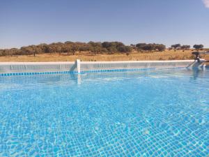 a large pool of water with a white fence at Quinta do Mocho by Portus Alacer in Arcos