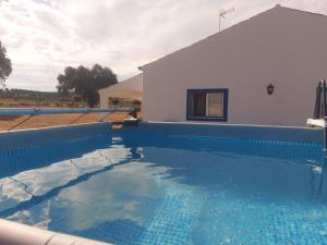 a swimming pool in front of a house at Quinta do Mocho by Portus Alacer in Arcos