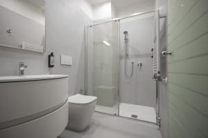 a bathroom with a shower and a toilet and a sink at Hotel Sogno del Benaco in Limone sul Garda